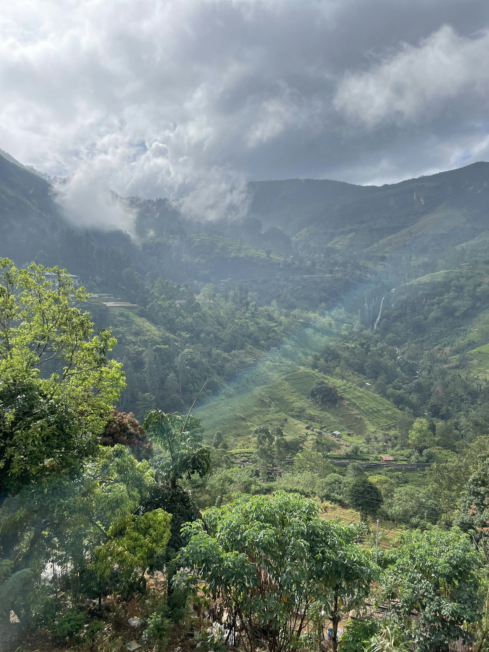Dramatic misty mountain peaks, rugged highland terrain, green valleys, Sri Lanka highlands