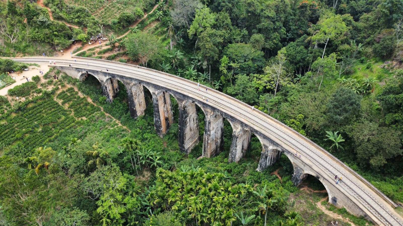 Nine Arches Bridge Ella Sri Lanka, stone viaduct surrounded by tea estates, misty morning